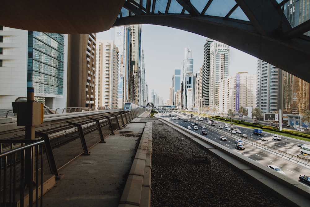 cars on road near city buildings during daytime