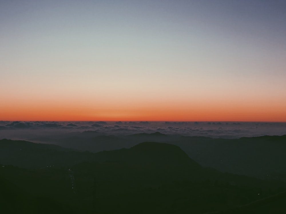 silhouette of mountains during sunset