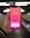 A hand holding a smartphone displaying the Tinder app login screen, with options to log in using Google or a phone number. The background is blurred, suggesting a dynamic setting, possibly a moving walkway or escalator.