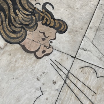 A floating figure with flowing hair surrounded by delicate, swirling wind motifs.