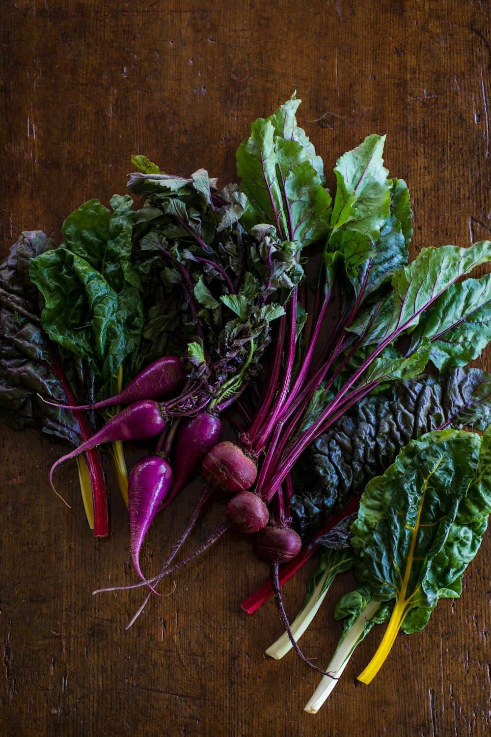 green and purple vegetable on brown wooden table