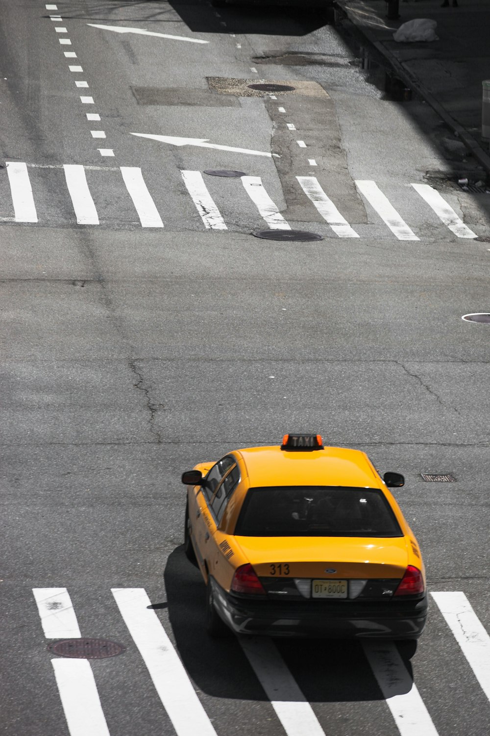 yellow taxi cab on road during daytime