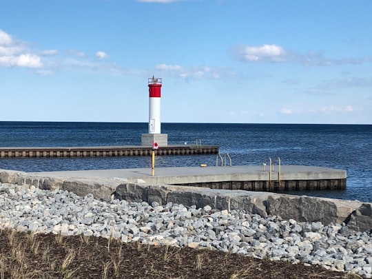 red and white lighthouse near sea during daytime in Oakville Canada