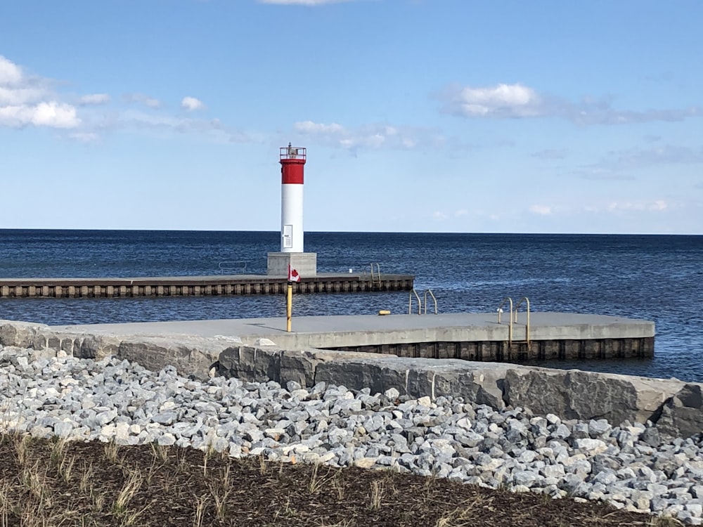 red and white lighthouse near sea during daytime