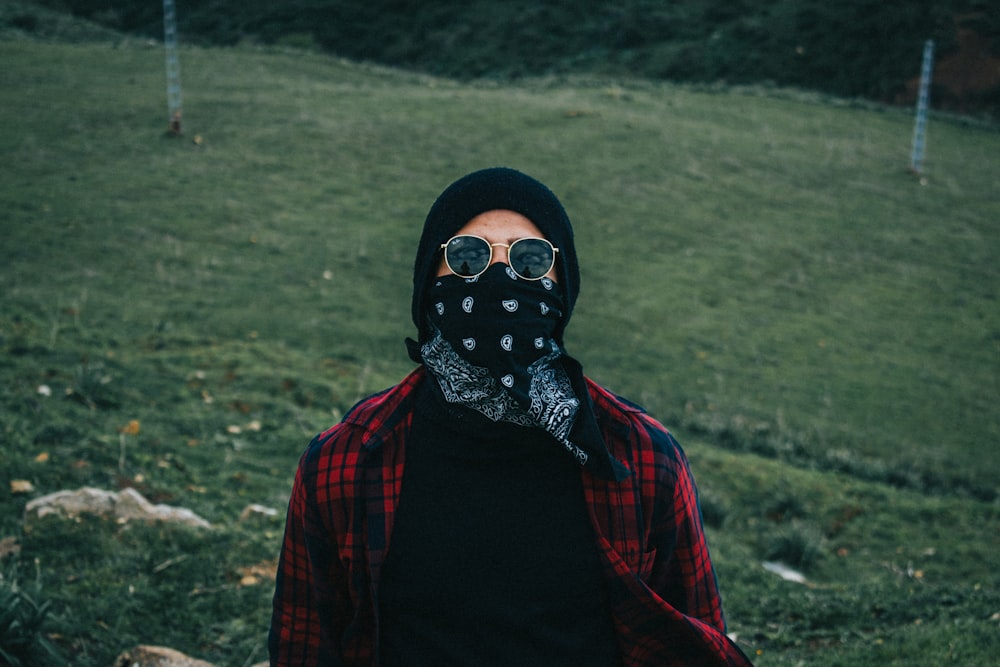 woman in black hijab and red and black plaid scarf