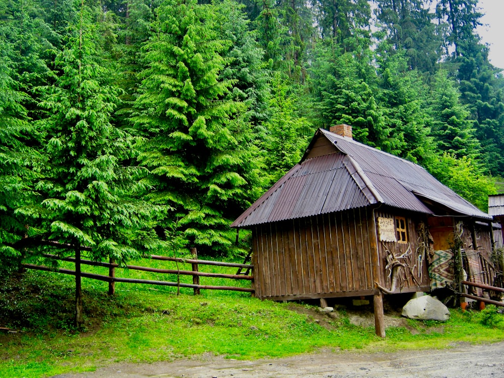 brown wooden house near green trees during daytime