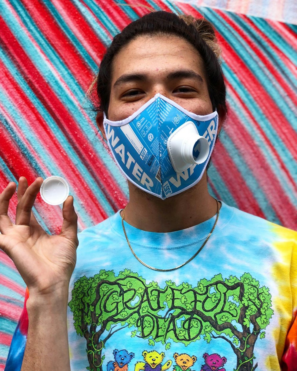boy in green crew neck shirt with blue mask