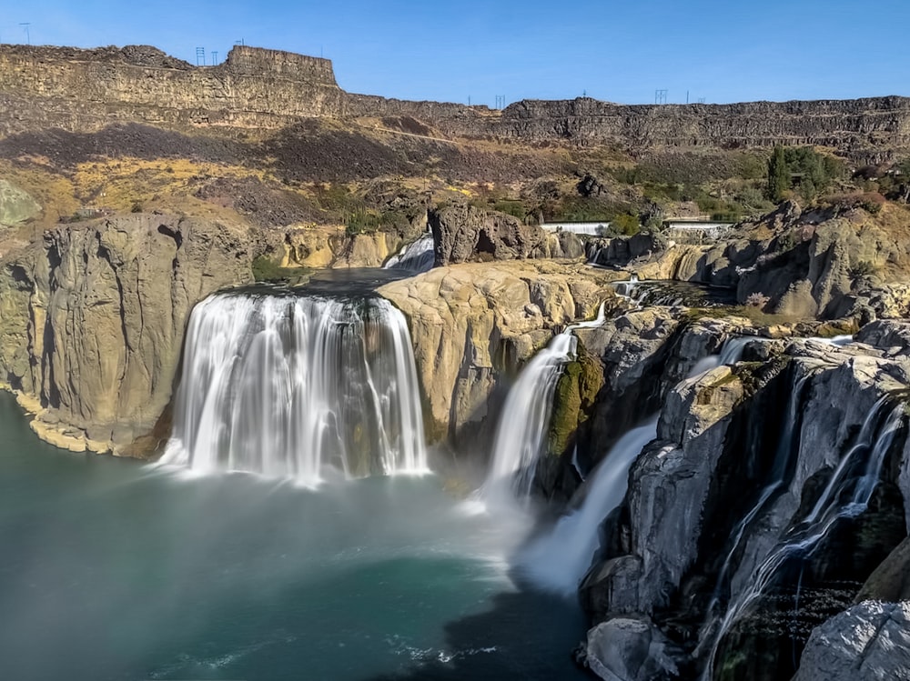 water falls on brown mountain during daytime