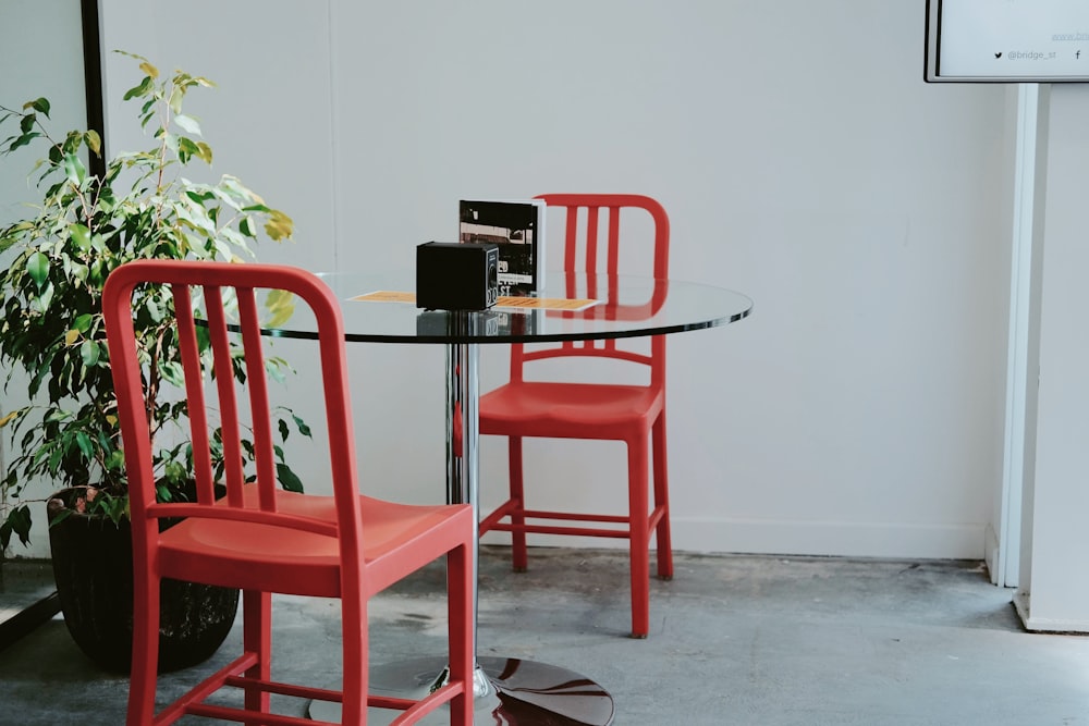 red plastic chair beside black table