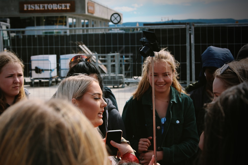 woman in black jacket standing beside woman in black jacket