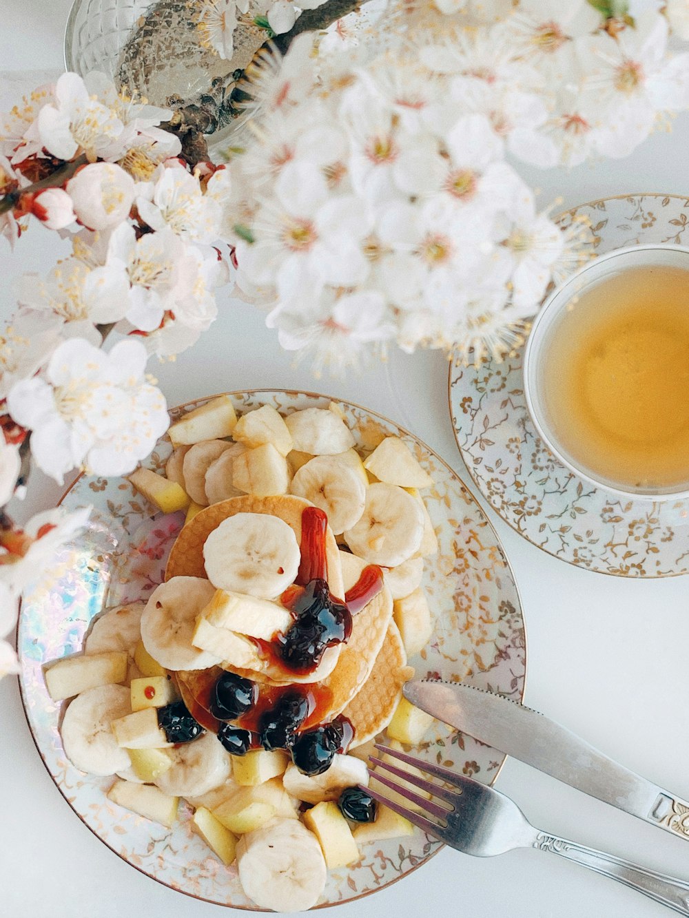 in Scheiben geschnittene Banane und Apfel auf weißer Keramikplatte