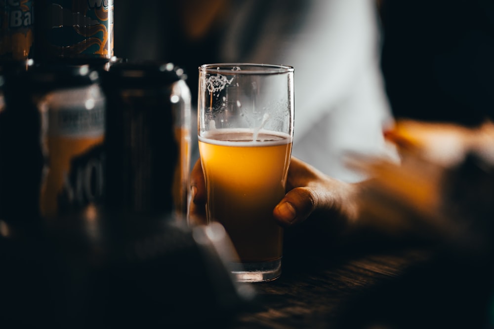 clear drinking glass with yellow liquid