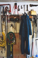 Forklift keys hanging on a pegboard in a workshop.