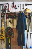 A vibrant display of various hand tools hanging on a pegboard in a home garage.