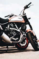 Various pitbike parts and accessories arranged neatly with orange accents.