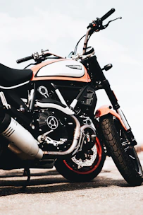 Various pitbike parts and accessories arranged neatly with orange accents.