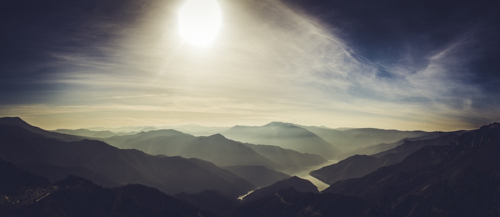 mountains under white clouds during daytime