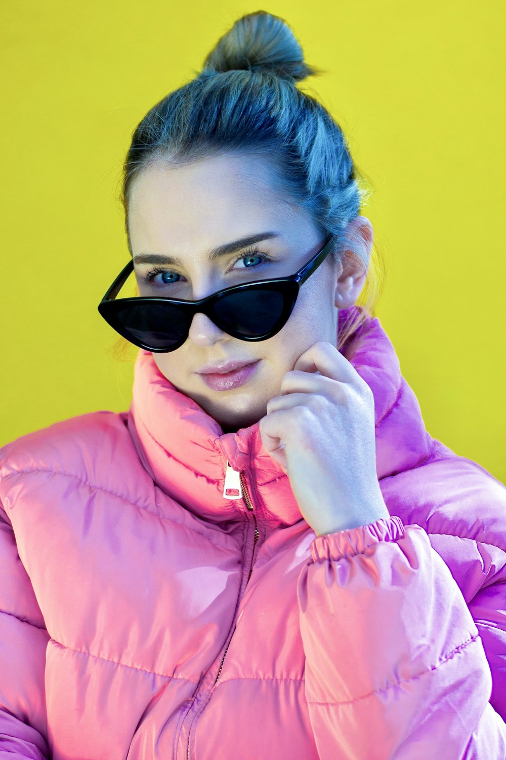 woman in pink zip up jacket wearing black sunglasses