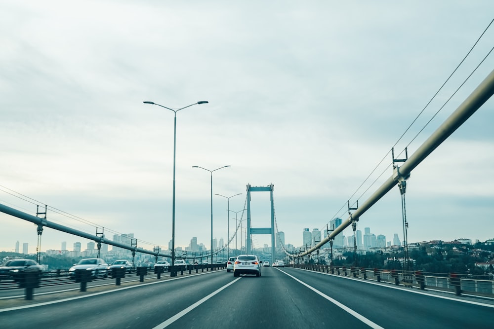 cars on road under cloudy sky during daytime