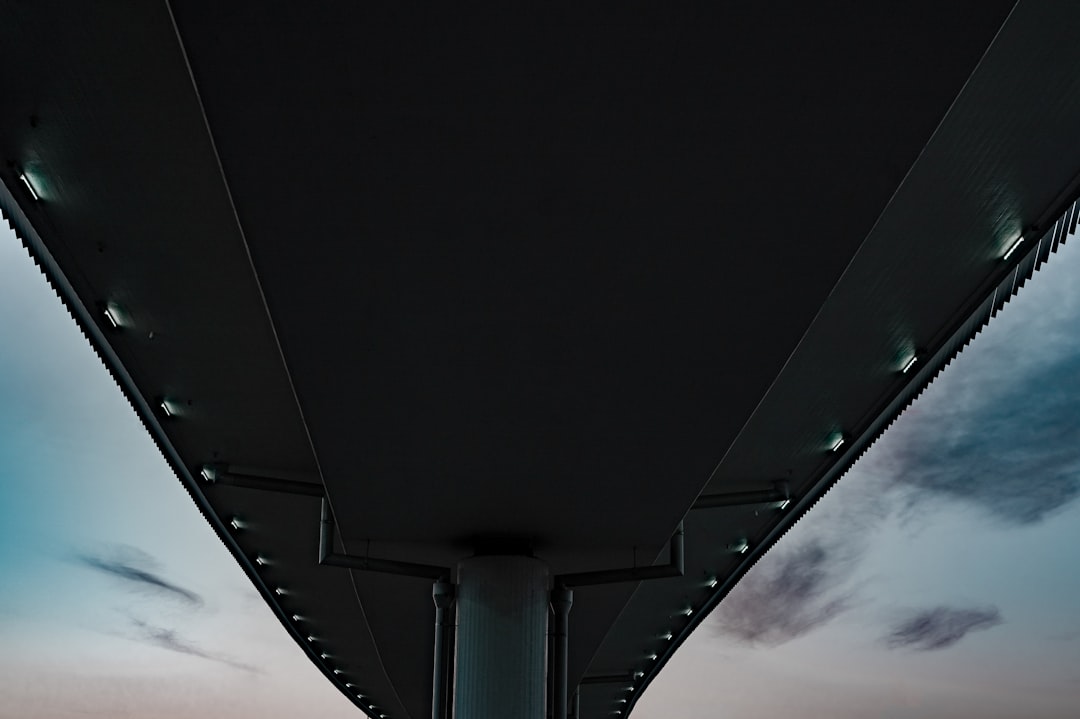 white concrete bridge under white sky during daytime