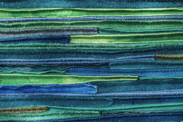 An elegant arrangement of colorful fabrics folded neatly, highlighting texture and color harmony