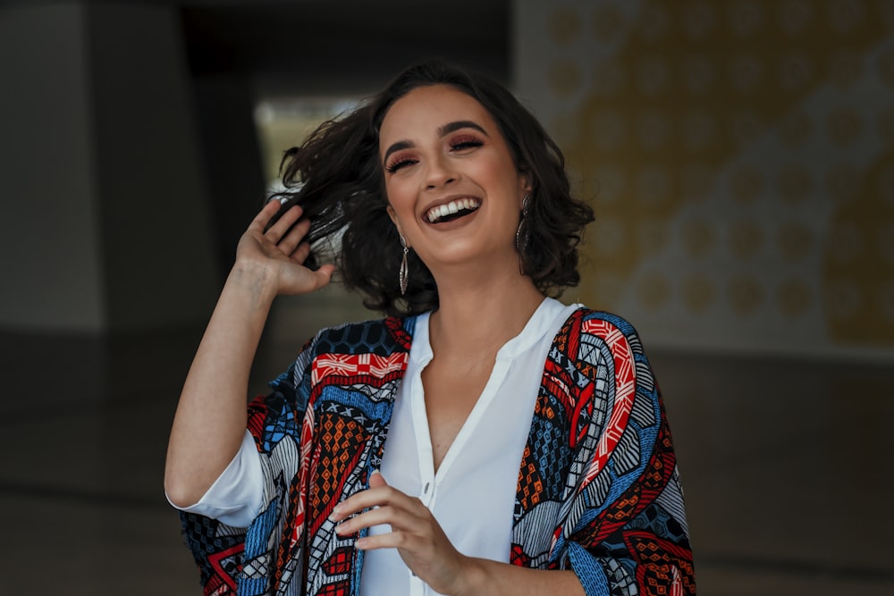 woman in white button up shirt smiling