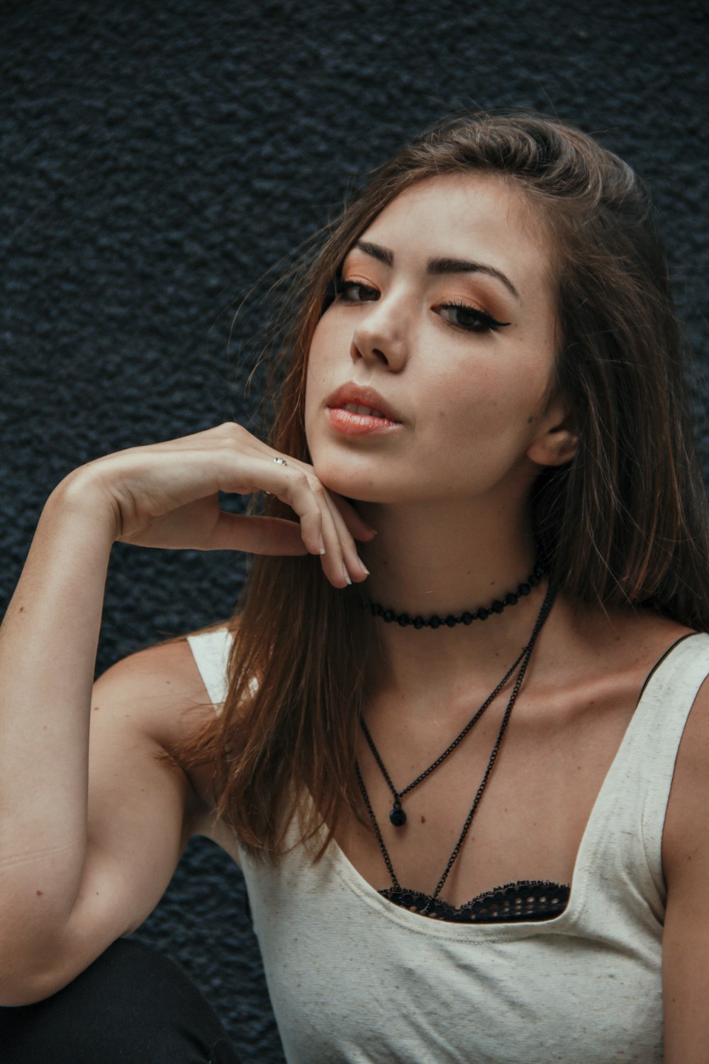 woman in white tank top wearing black beaded necklace