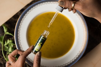 A hand sprinkling Sea Balance Salts onto a steaming bowl of homemade soup.