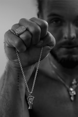 Man wearing a pendant necklace with a powerful emblem symbolizing integrity.