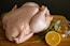 raw chicken meat on brown wooden chopping board