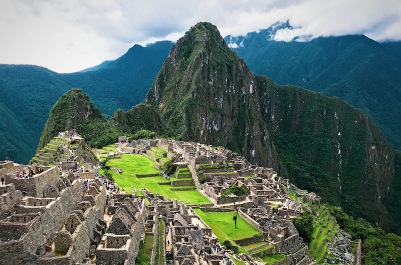 Ancient Incan citadel of Machu Picchu surrounded by mountains and clouds in Peru
