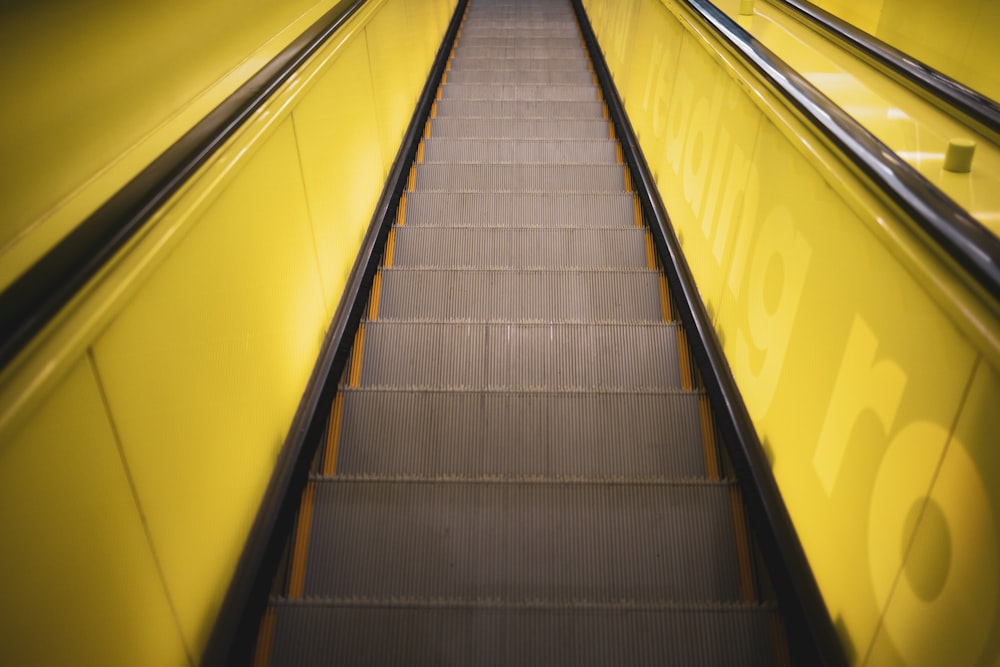 black and yellow escalator in close up photography