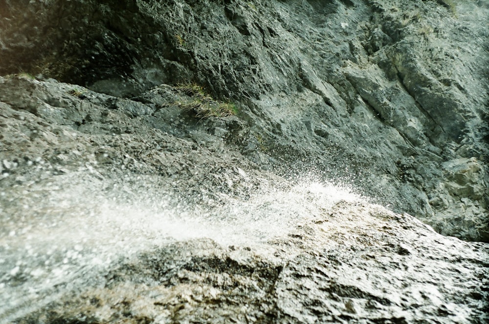 water waves hitting rocky shore during daytime