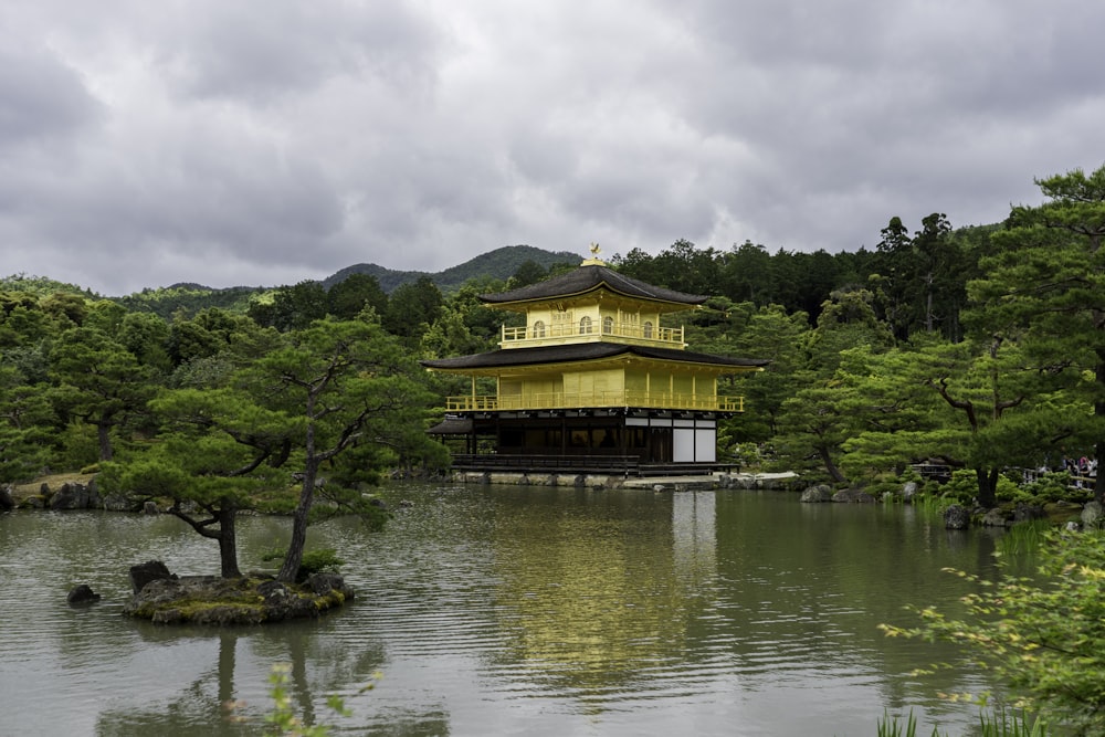 brown and green wooden house on body of water during daytime