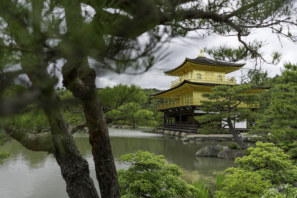 brown and white temple near body of water during daytime