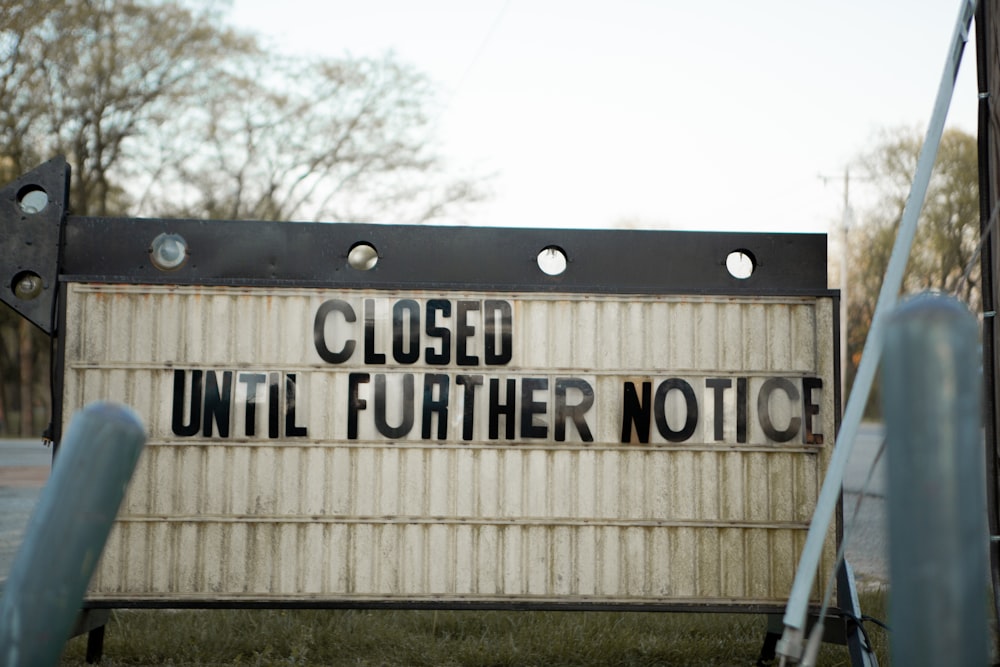 white and black wooden signage