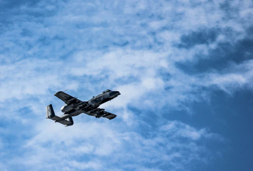 A military aircraft soaring through the sky.