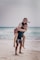 woman in blue denim shorts standing on beach during daytime