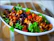 A vibrant salad topped with naturepure&amp;#x27;s savory crunchy mix, set on a cozy kitchen counter.