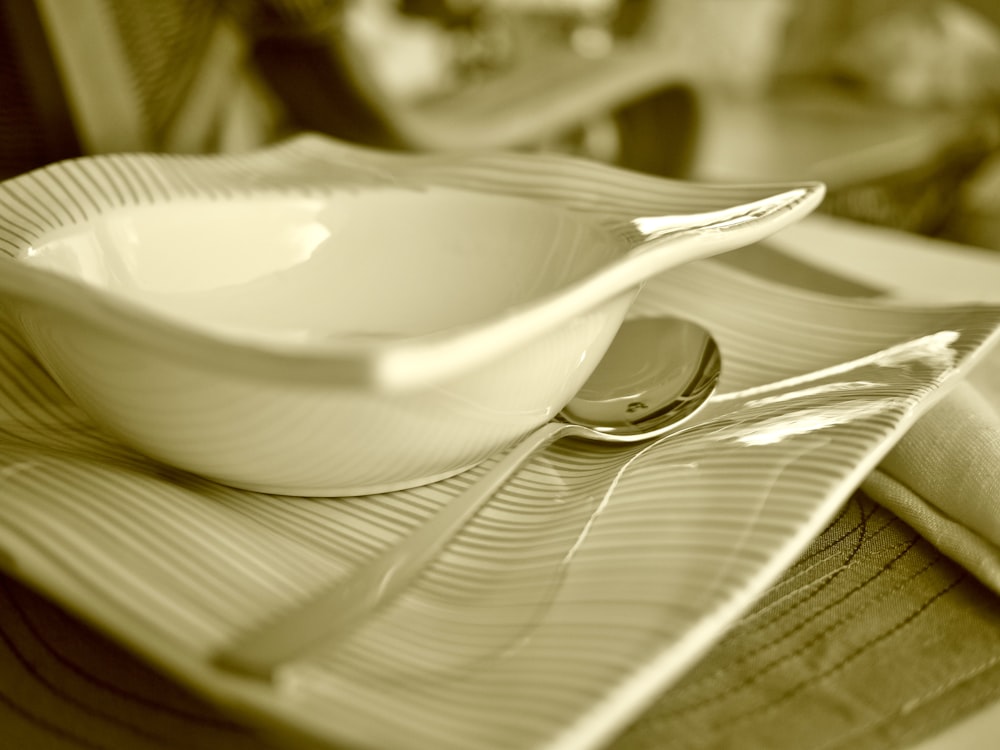 white ceramic bowl on silver spoon