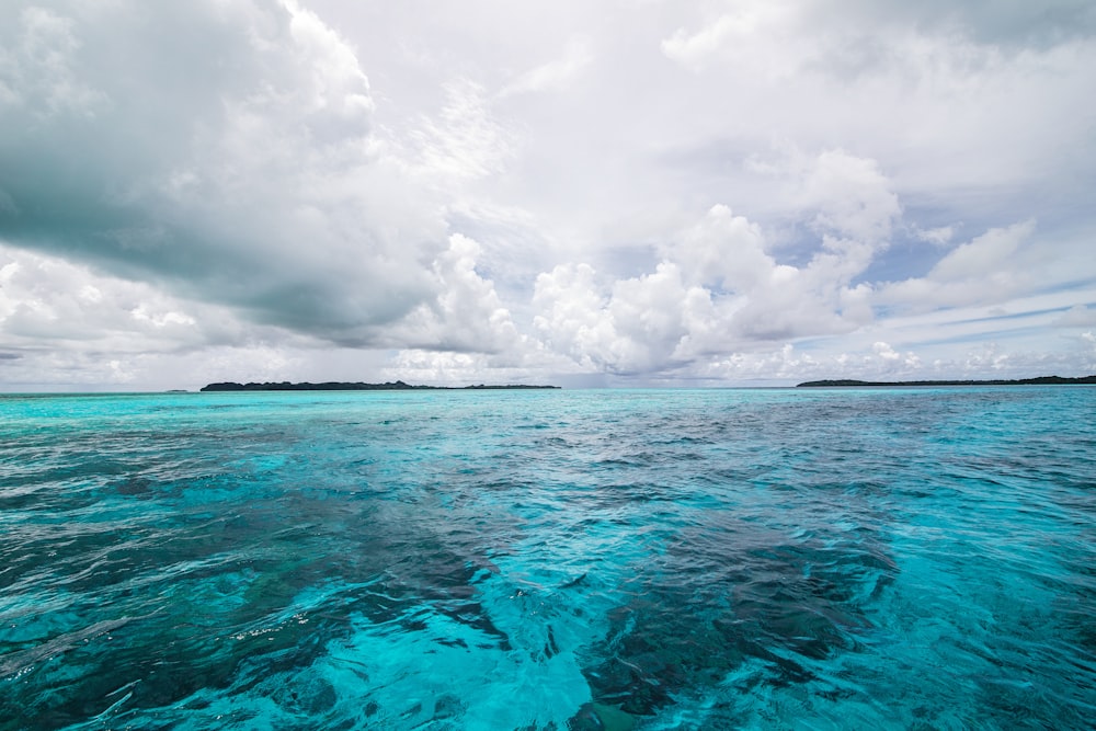 blue sea under white clouds during daytime