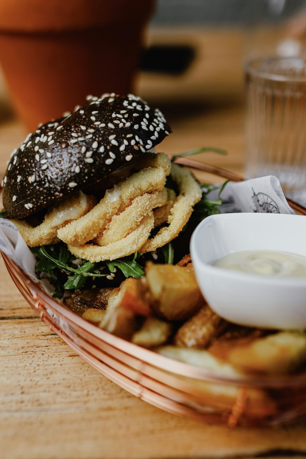 burger with fries on red and white ceramic plate