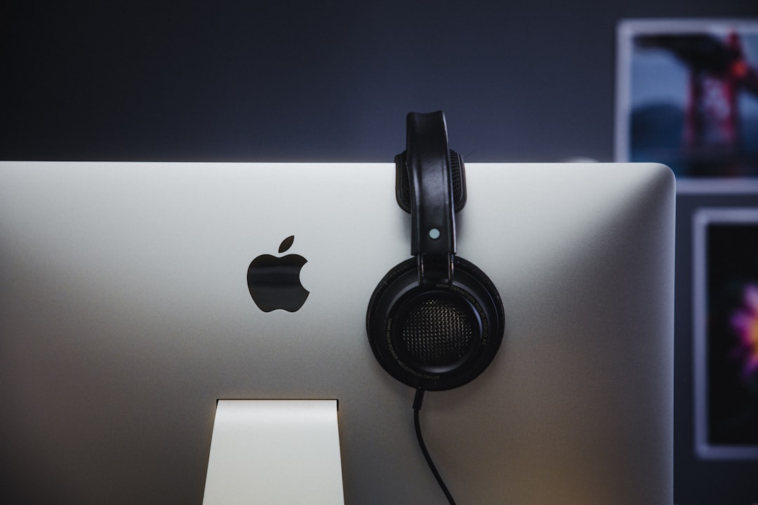 black headphones on silver imac