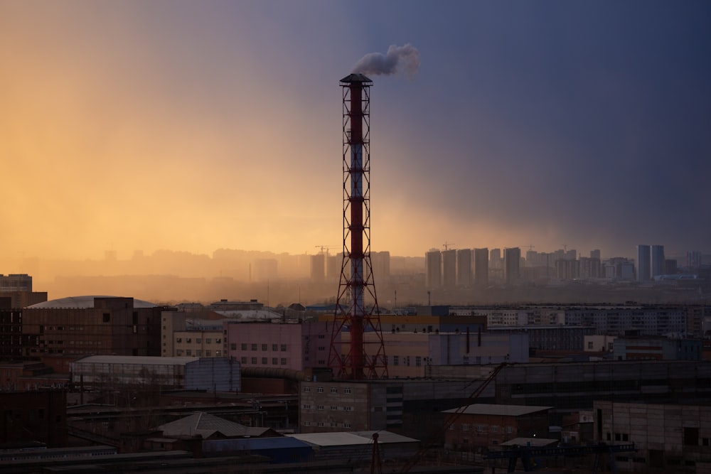 red tower near white concrete building during daytime