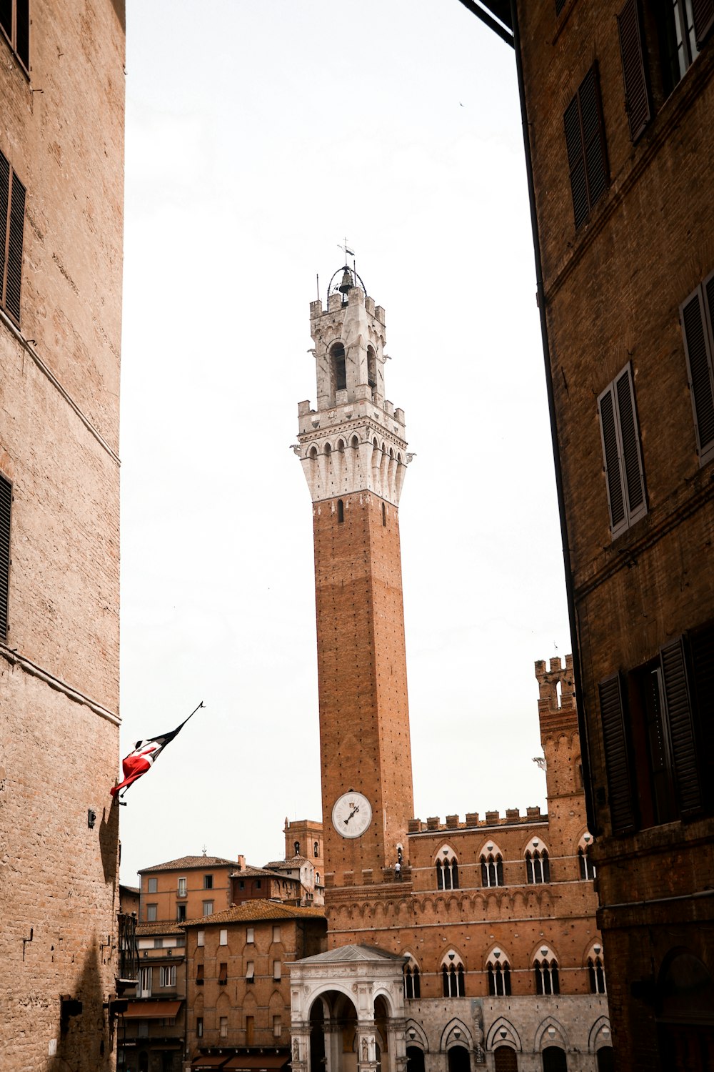 brown concrete tower with red flag on top