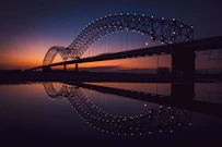 bridge over body of water during night time