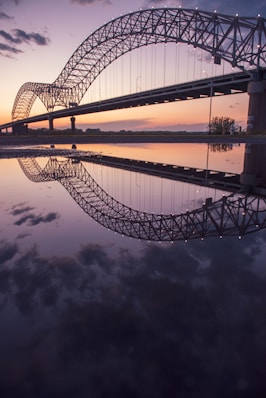 gray steel bridge over body of water during night time