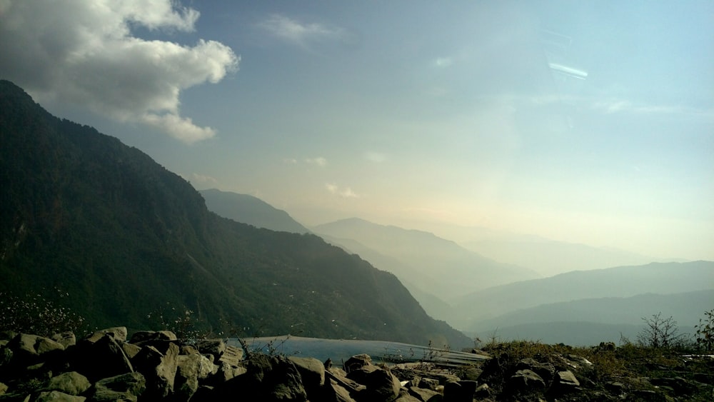 green mountains near body of water during daytime