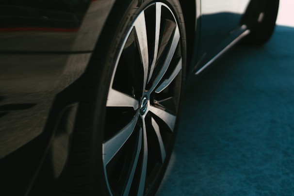 A sleek aluminum wheel displayed in a modern showroom.