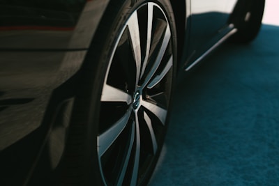 Close-up of a shiny imported alloy wheel mounted on a sleek pickup truck.